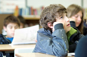 student sitting at desk, paying attention